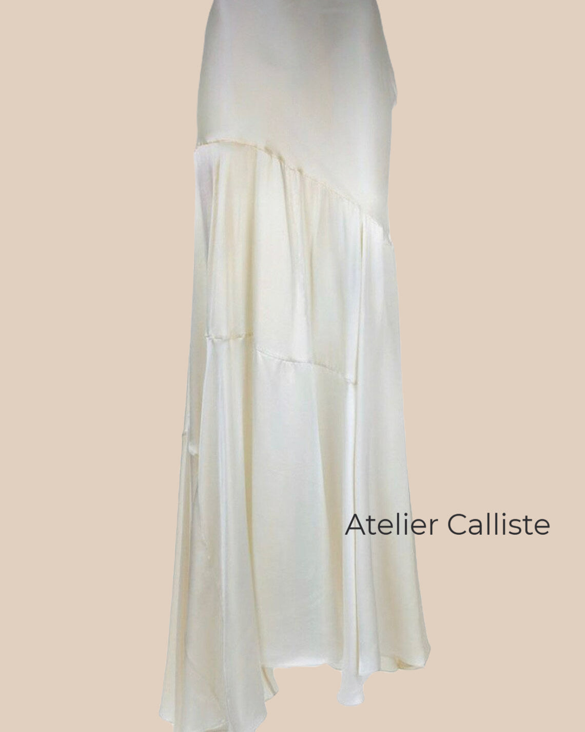 Asymmetrical satin skirt by Atelier Calliste, featuring a sleek, shiny fabric with a modern, uneven hemline.
