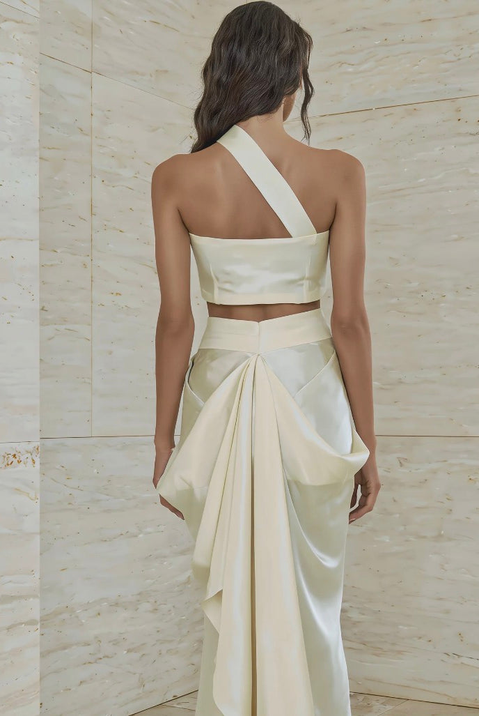Atelier Calliste Ieria asymmetrical dress with flowing fabric and unique hemline, displayed on a mannequin.