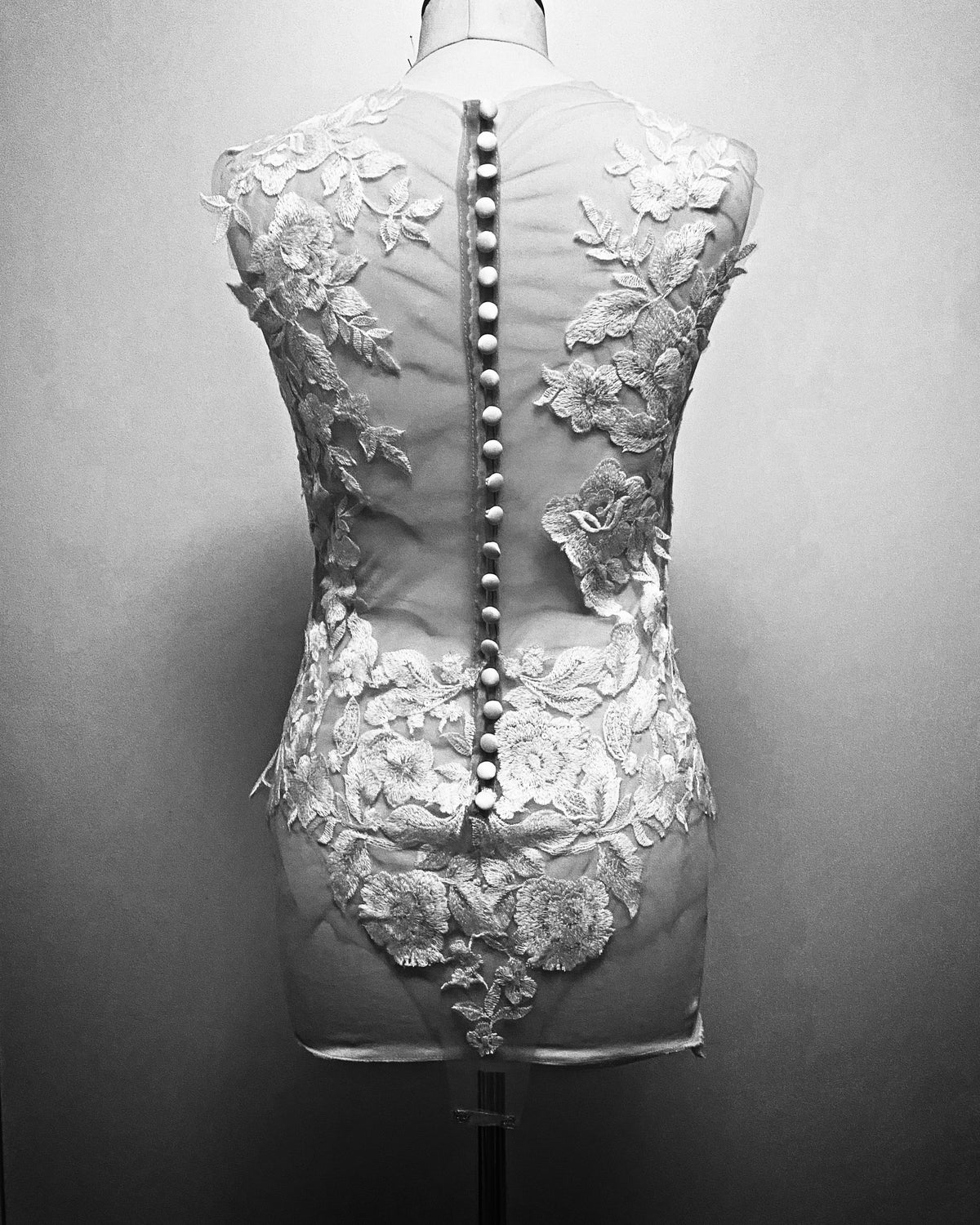 Mythic Nymph bridal bodysuit top by PETRA KARA featuring intricate lace, sheer fabric, and a delicate, elegant design.