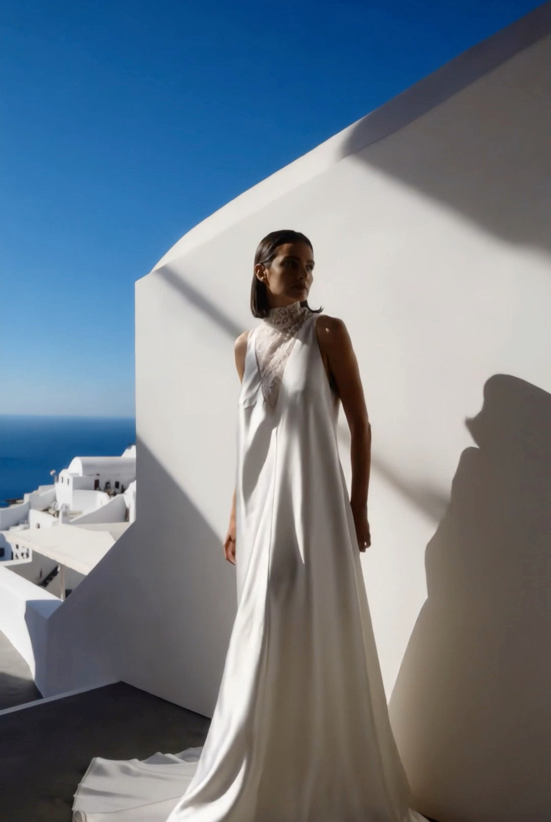 Petra Kara Santorini Elegance Architectural Dress displayed on a hanger, featuring intricate design and flowing fabric.