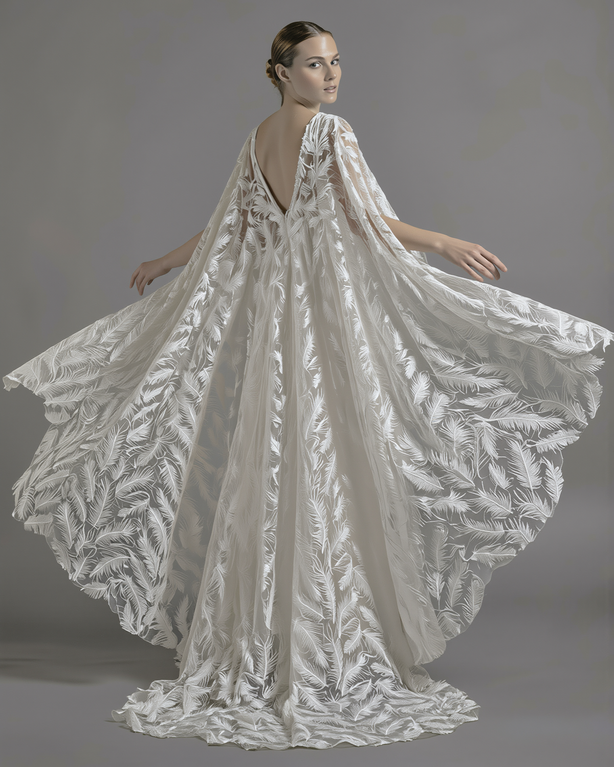 Feather veil and cape by Atelier Calliste, showcasing delicate feather details and flowing fabric for elegant fashion or costume wear.