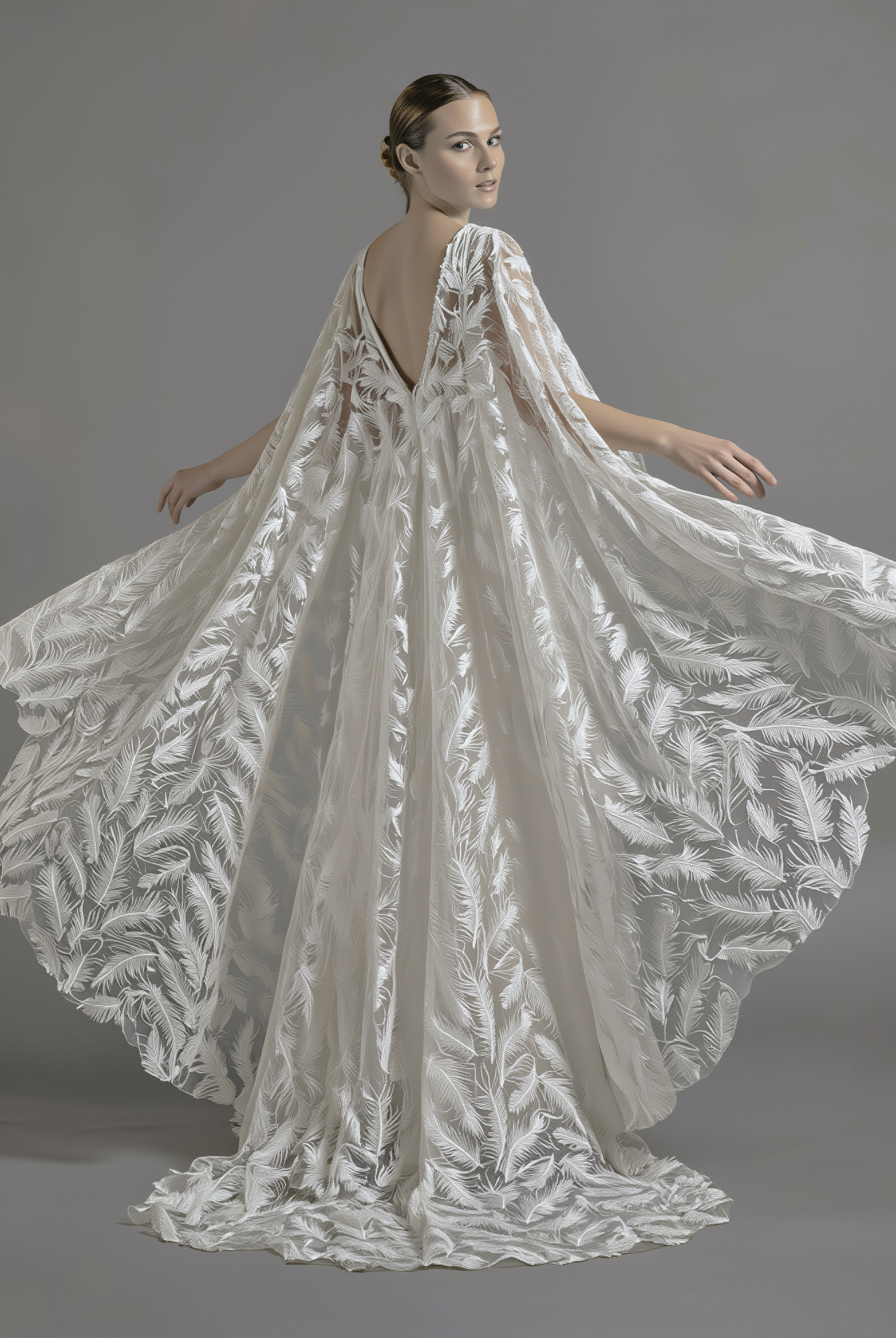 Feather veil and cape by Atelier Calliste, showcasing delicate feather details and flowing fabric for elegant fashion or costume wear.