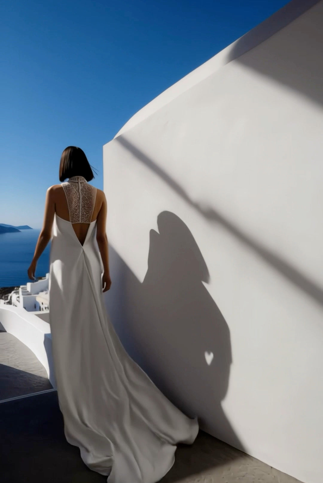 Petra Kara Santorini Elegance architectural dress displayed on a hanger, showcasing its intricate design and flowing fabric.