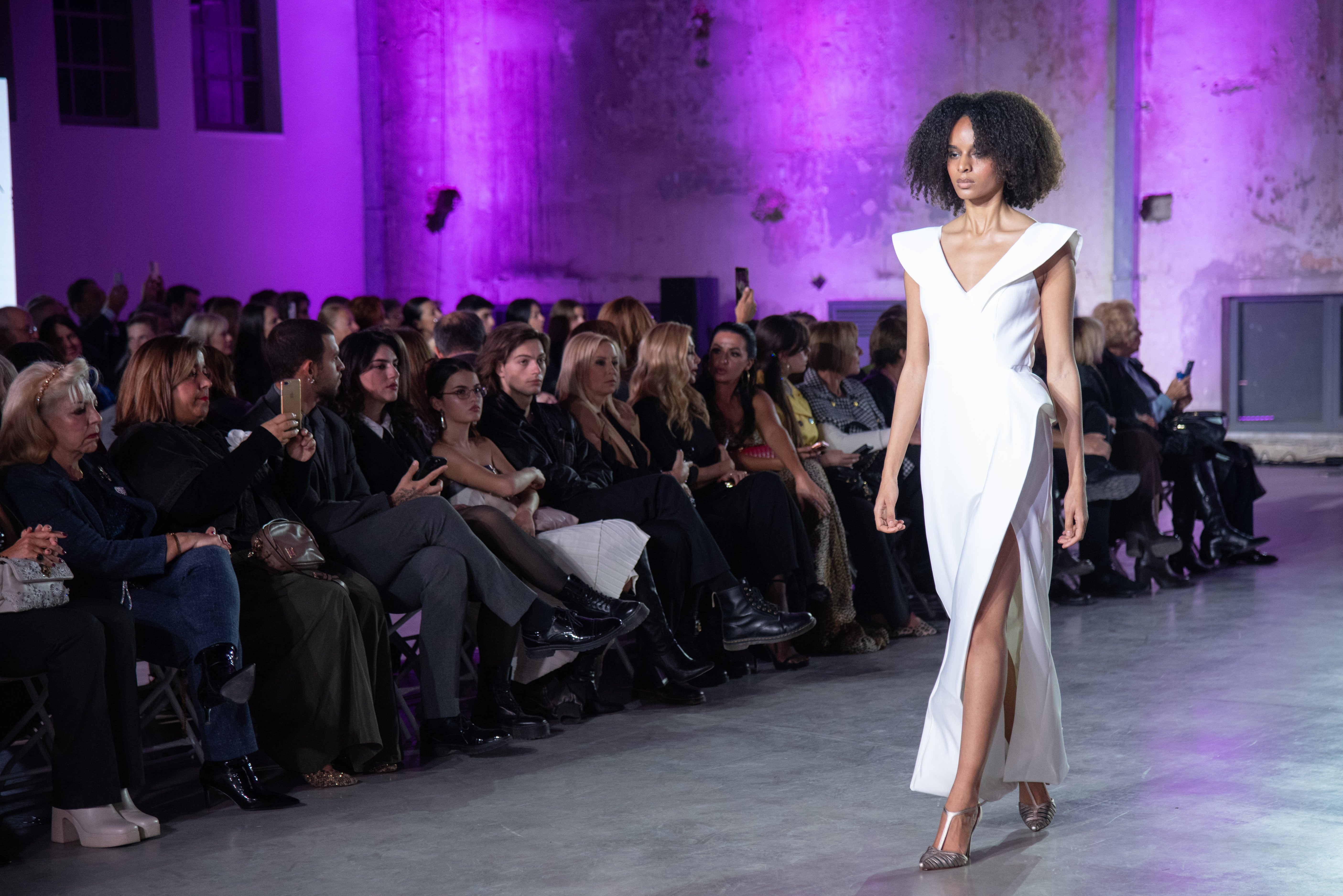 Aegean Architectural Dress by PETRA KARA displayed on a mannequin, featuring intricate architectural-inspired design and flowing fabric.
