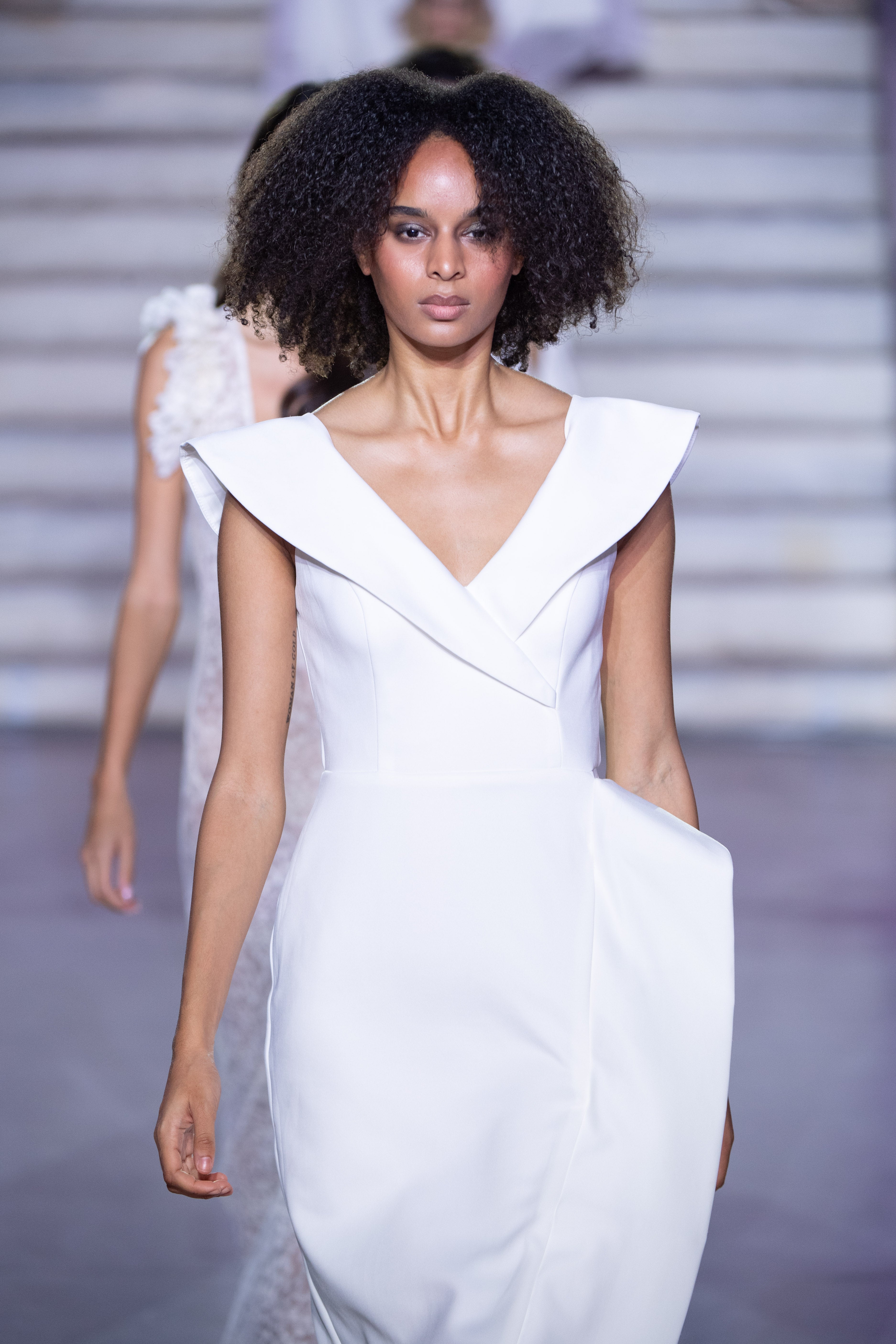 Aegean Architectural dress by PETRA KARA featuring intricate blue and white patterns inspired by Mediterranean architecture.