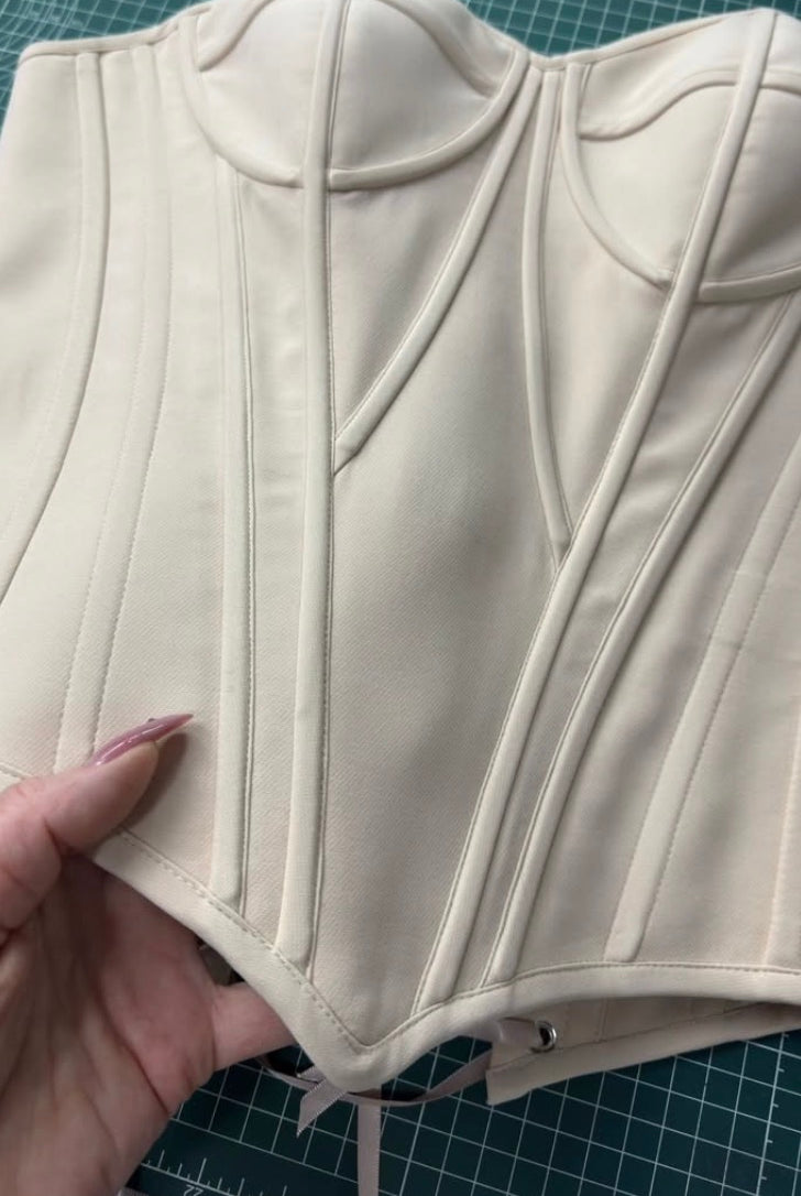Elegant architectural corset wedding dress by Petra Kara Bridal featuring structured design and intricate detailing.