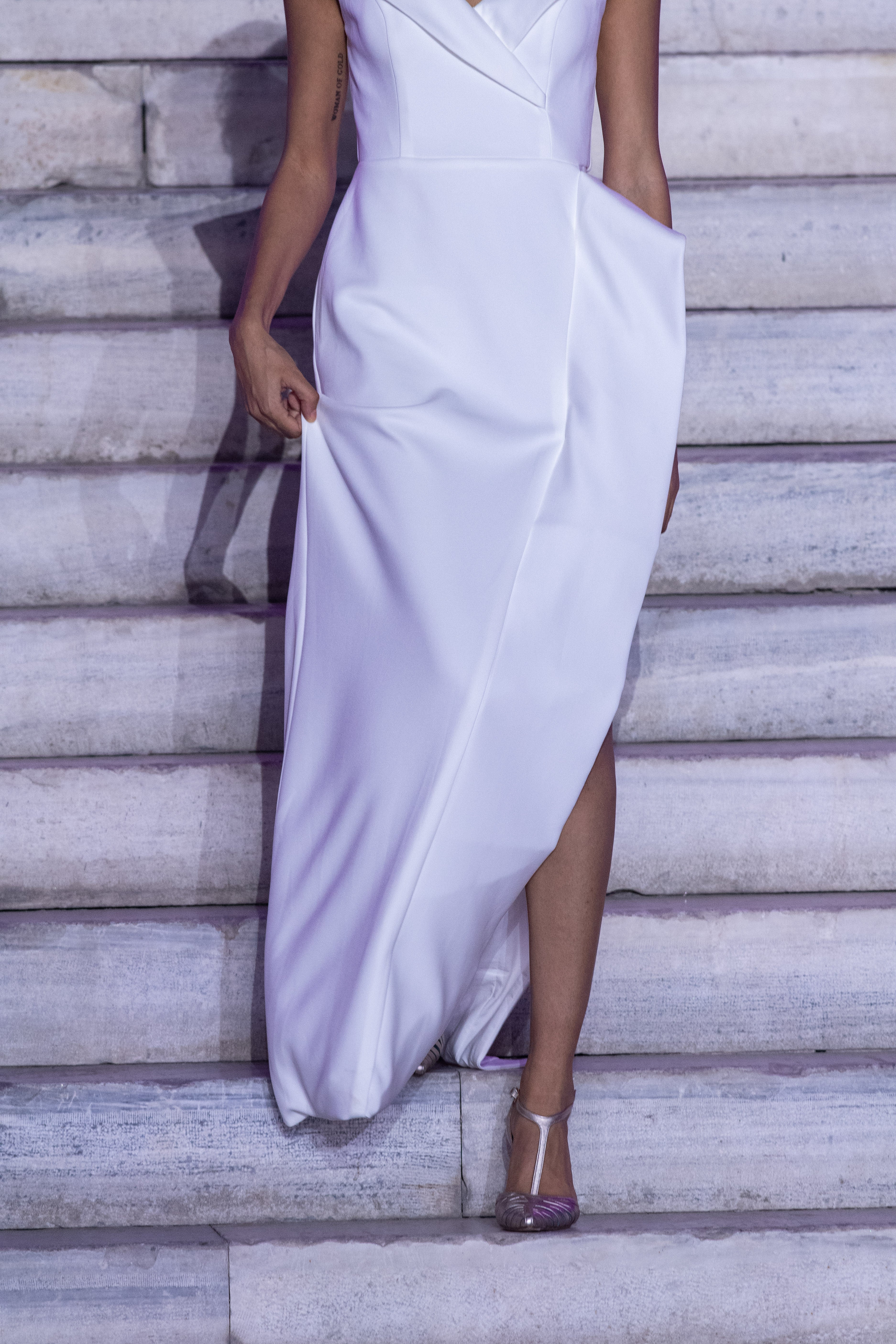 Aegean Architectural Dress by PETRA KARA featuring intricate geometric patterns and flowing fabric in neutral tones.