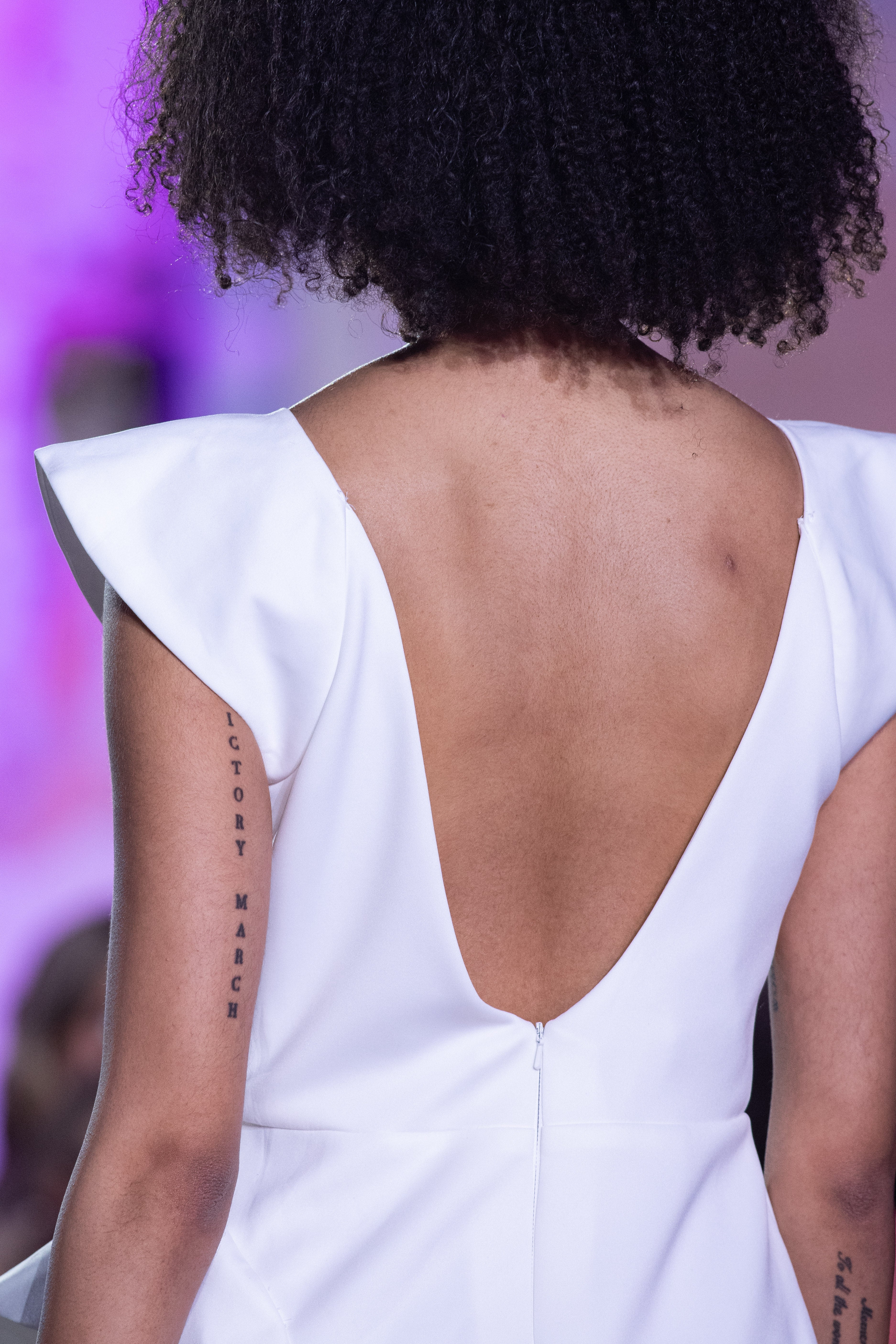 Petra Kara Aegean Architectural Dress displayed on a mannequin, featuring flowing fabric and intricate design details.