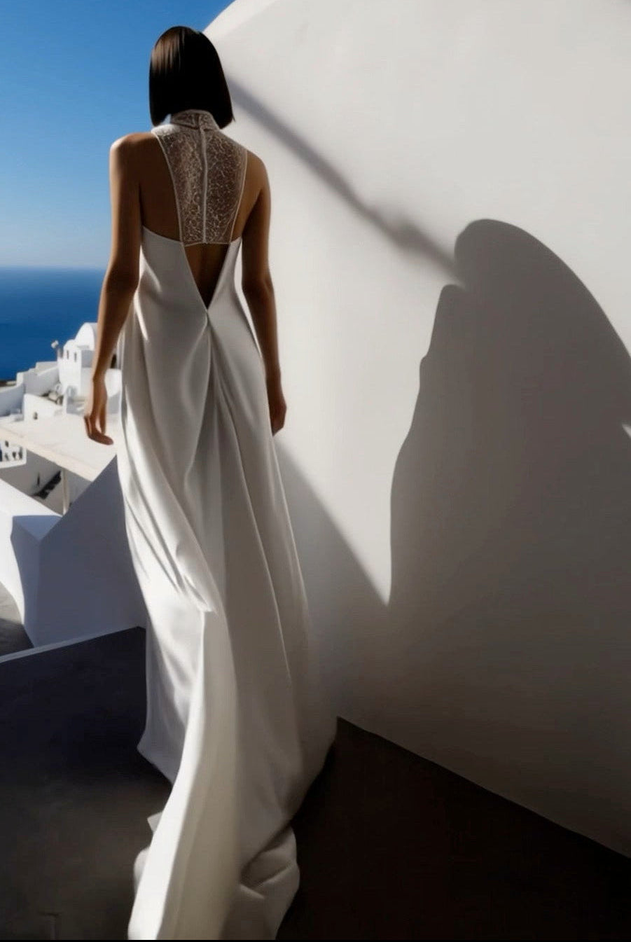 Petra Kara Santorini Elegance architectural dress displayed on a model, featuring flowing fabric and intricate design details.