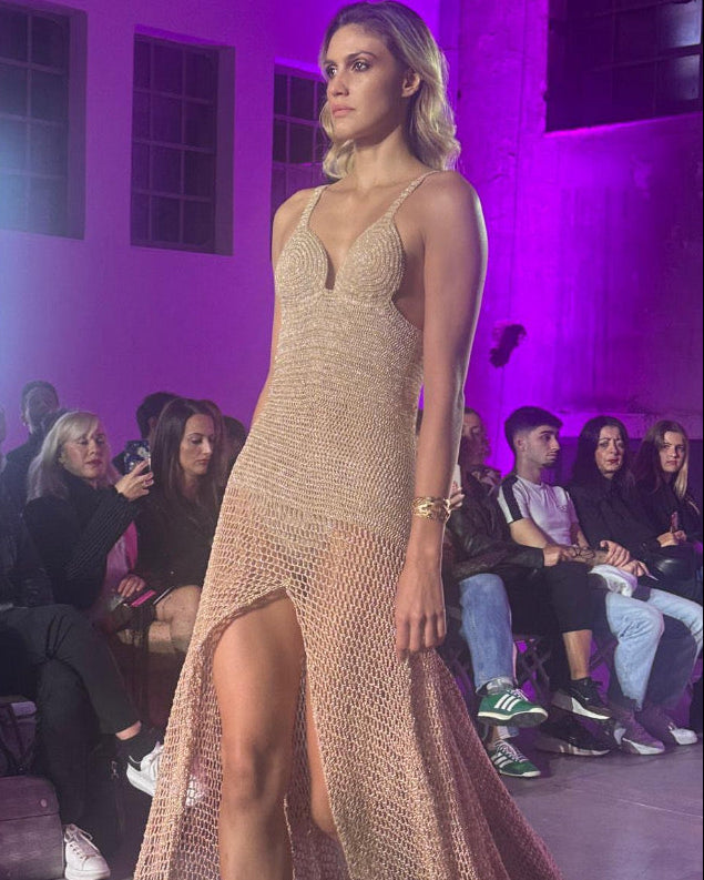 Petra Kara KORI special occasion gold crochet art dress displayed on a mannequin with intricate crochet details and elegant fit.