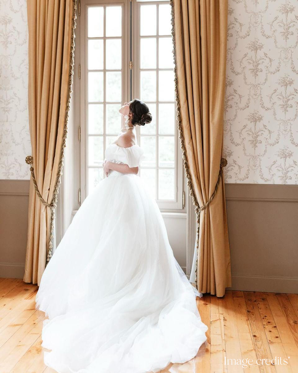 Ethereal white silk Adrielle earrings by PM Atelier featuring dreamy statement design for brides, shown on a model.