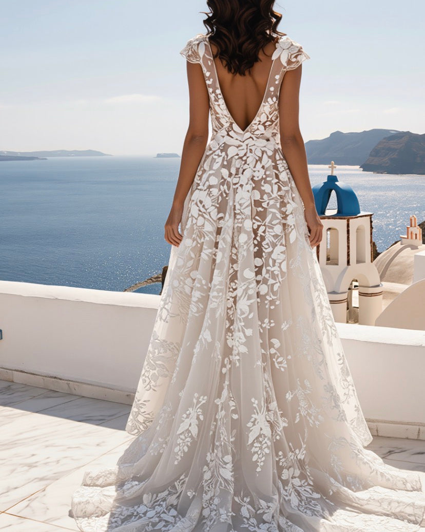 Spring 3D floral boho wedding dress by Petra Kara Bridal with intricate floral details and flowing fabric.