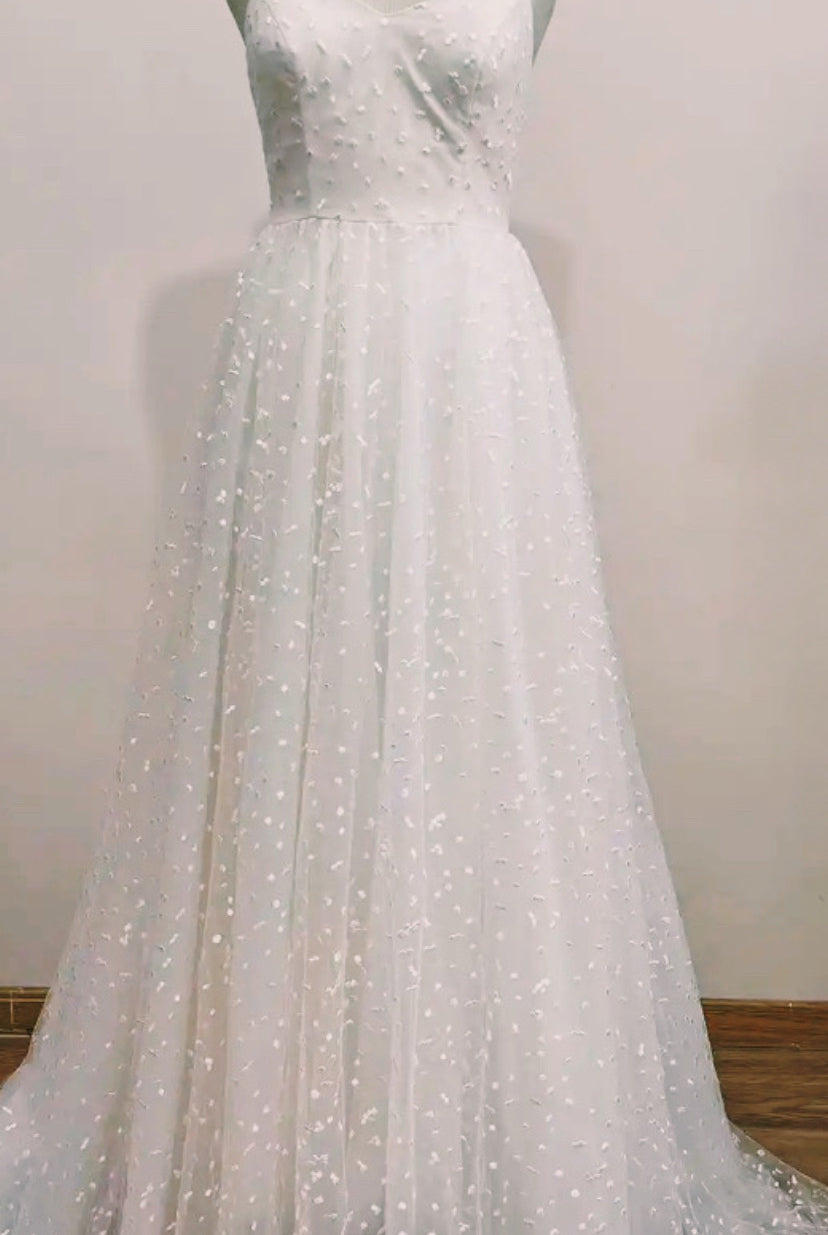 Boho wedding dress from STARS by Atelier Calliste featuring lace details and flowing fabric for a romantic bridal look.