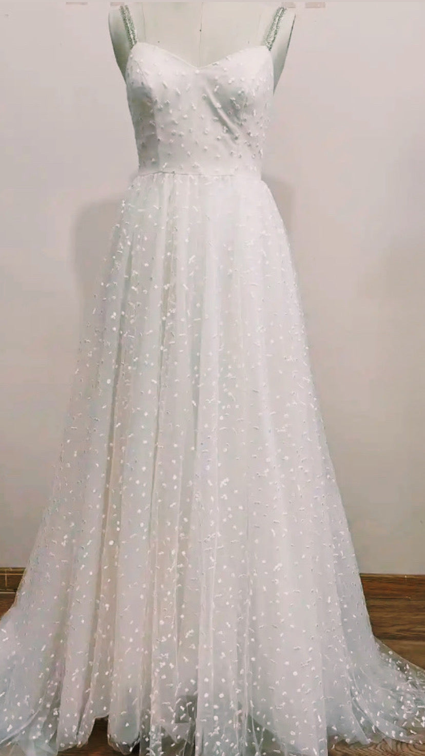 Boho wedding dress from STARS by Atelier Calliste featuring lace details and flowing fabric for a romantic bridal look.