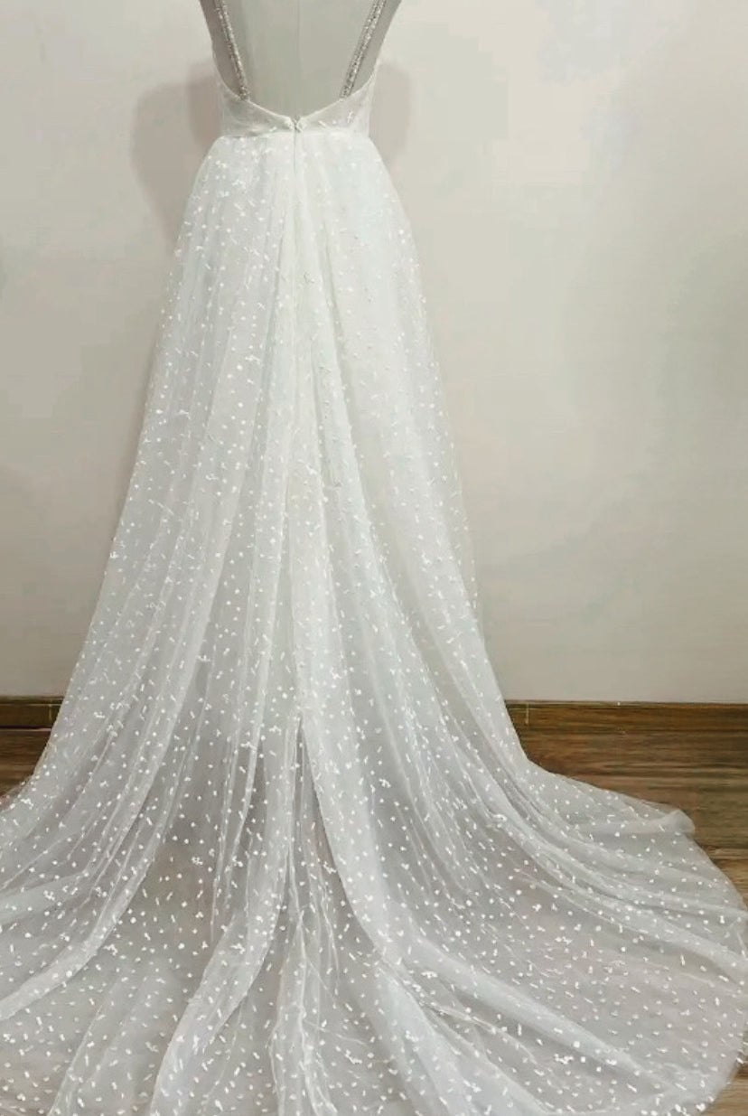 Boho wedding dress from STARS collection by Atelier Calliste, featuring flowing fabric and intricate details.