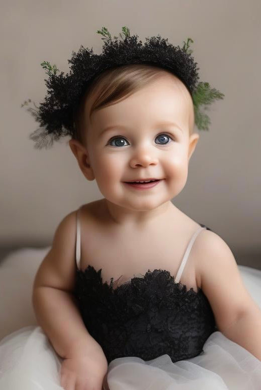 Black Swan baby dress by Atelier Calliste, featuring soft fabric and delicate design for a stylish infant outfit.