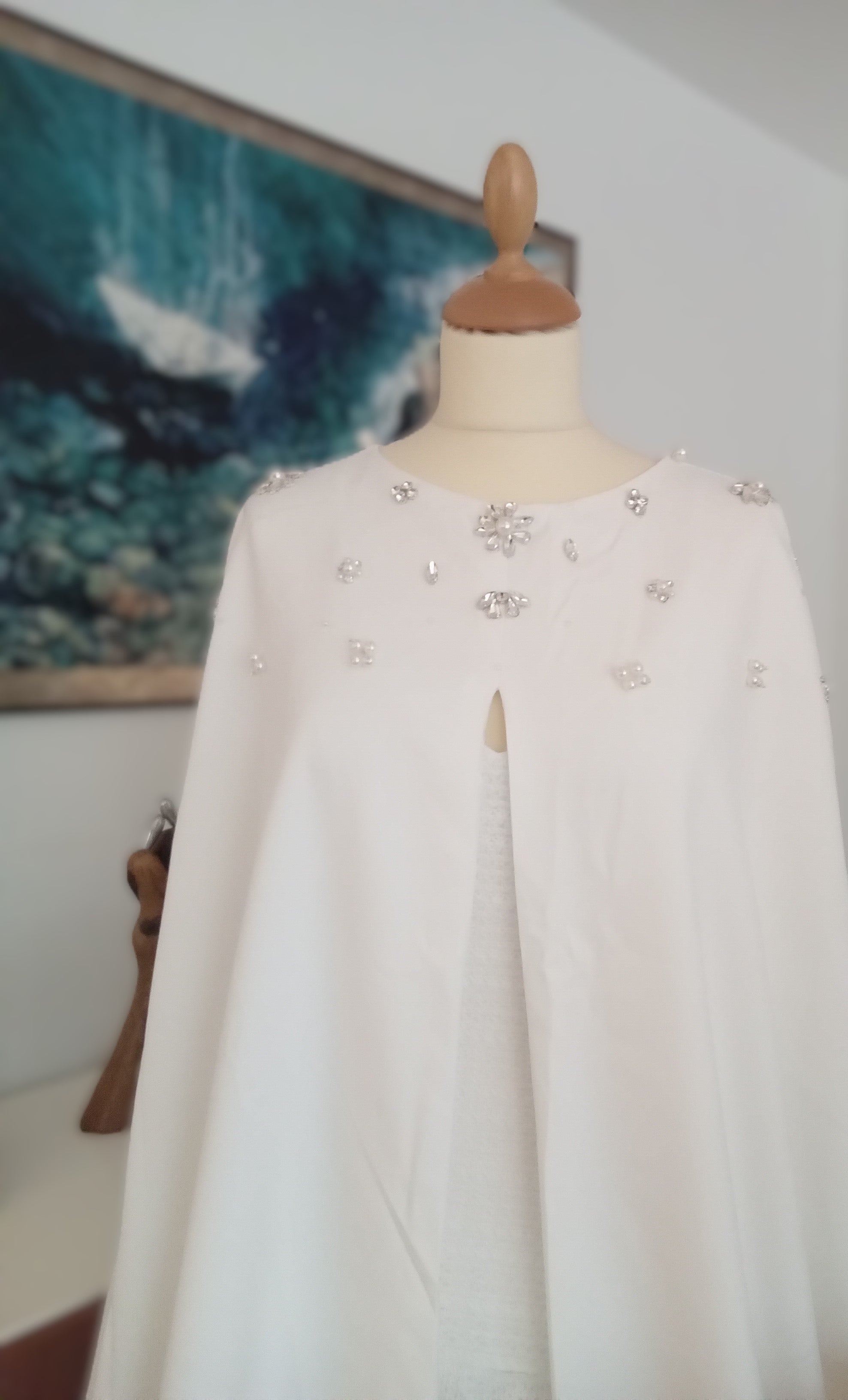 Beaded cape by Atelier Calliste in size S to XXXL, featuring intricate beaded detailing and flowing fabric for elegant wear.