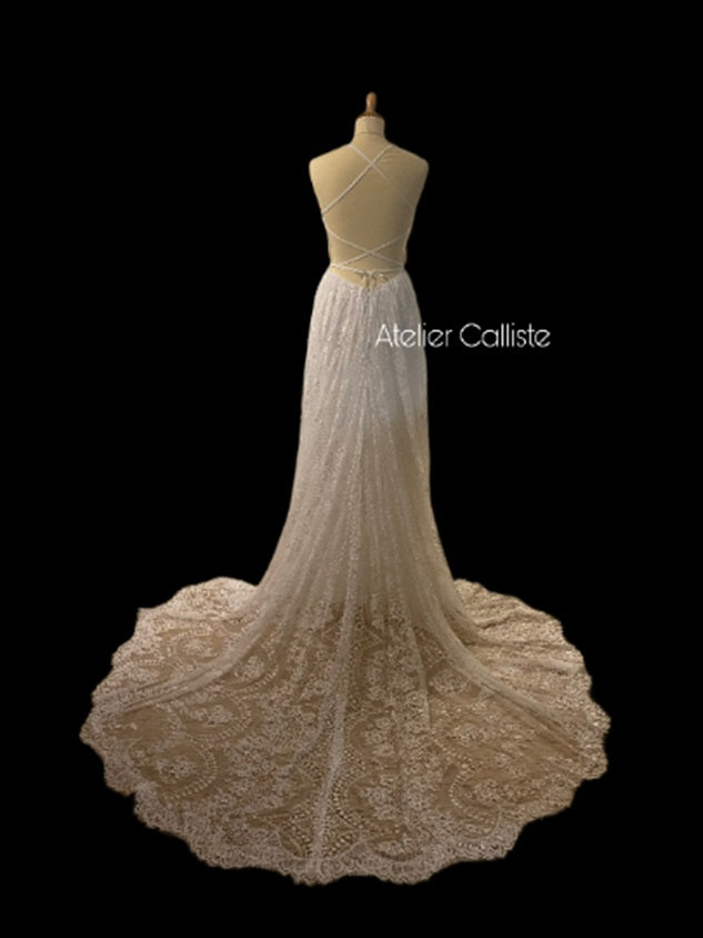 Atelier Calliste boho wedding dress with flowing fabric and intricate lace details, perfect for a romantic bridal look.
