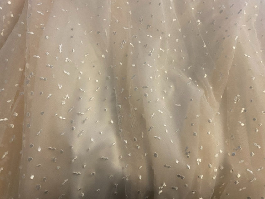 Boho wedding dress with star embellishments by Atelier Calliste, featuring flowing fabric and intricate lace details.
