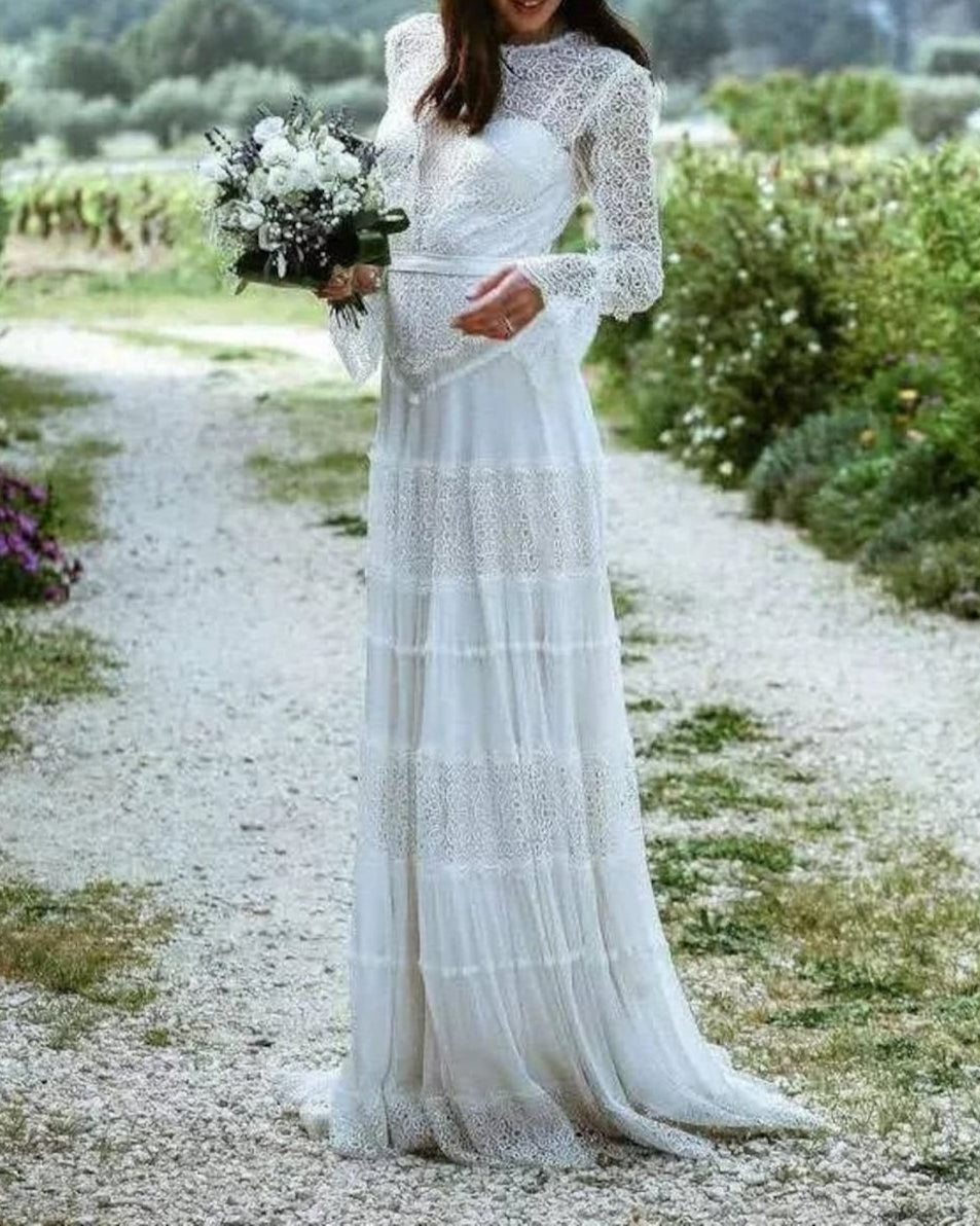 ELENI Boho wedding dress by Atelier Calliste featuring lace details and flowing fabric, displayed on a mannequin.