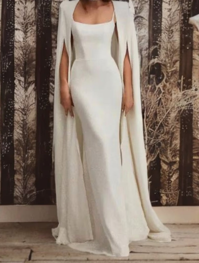 Black Atelier Calliste minimal cape in S-XXXL size, draped over a mannequin, showcasing sleek, modern design and elegant fabric details.