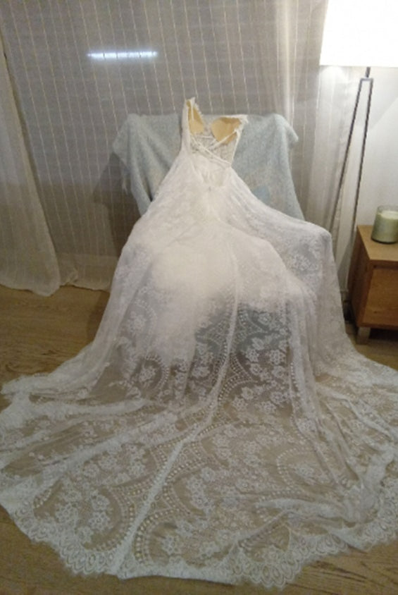 Elegant CELINE boho wedding dress by Atelier Calliste featuring flowing fabric and intricate detailing on a model.