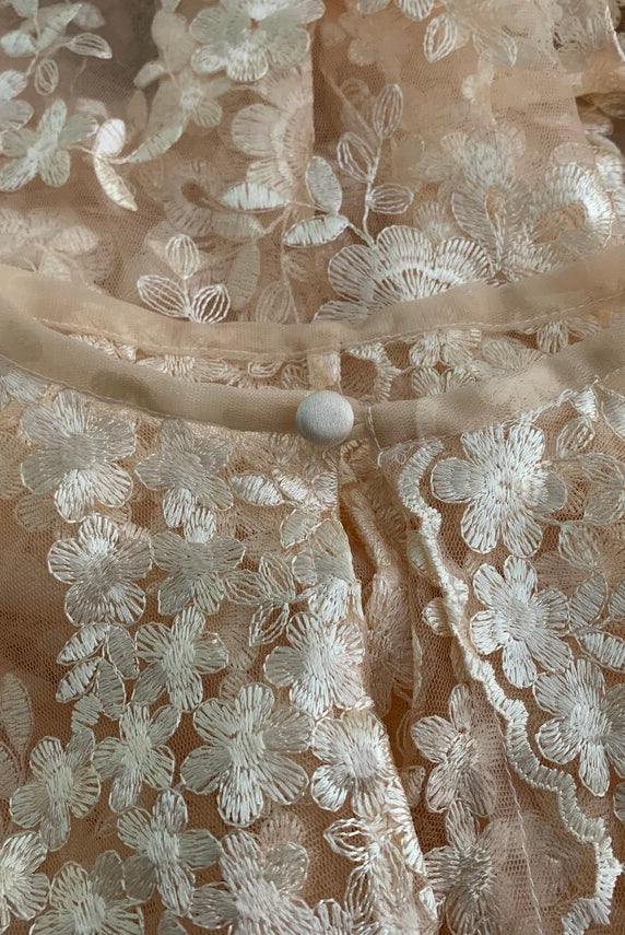 Elegant black lace cape from Petra Kara Bridal in size S to XXXL, detailed with intricate lace patterns and flowing fabric.
