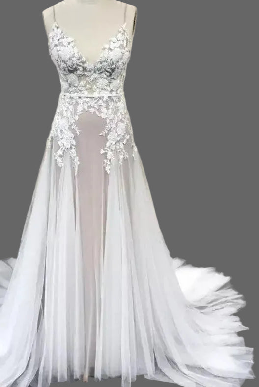 Elegant Lake Nymph Calliste wedding dress by Atelier Calliste featuring lace details and flowing fabric.