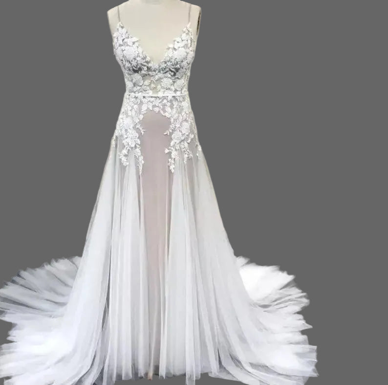 Elegant Lake Nymph Calliste wedding dress by Atelier Calliste featuring lace details and flowing fabric.