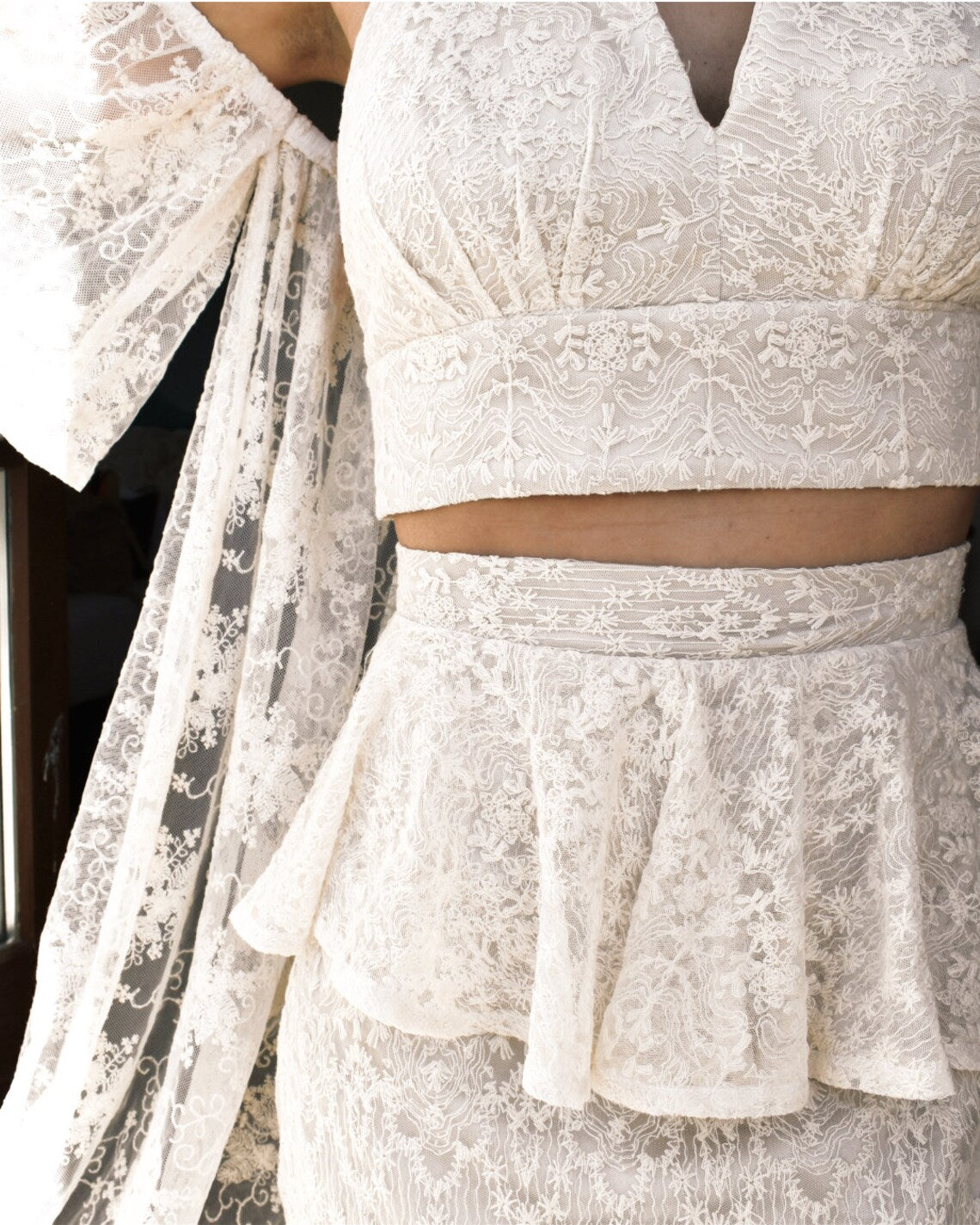 Elegant ELEANA CROP lace dress by PETRA KARA BRIDAL featuring intricate lace details and a fitted crop design.