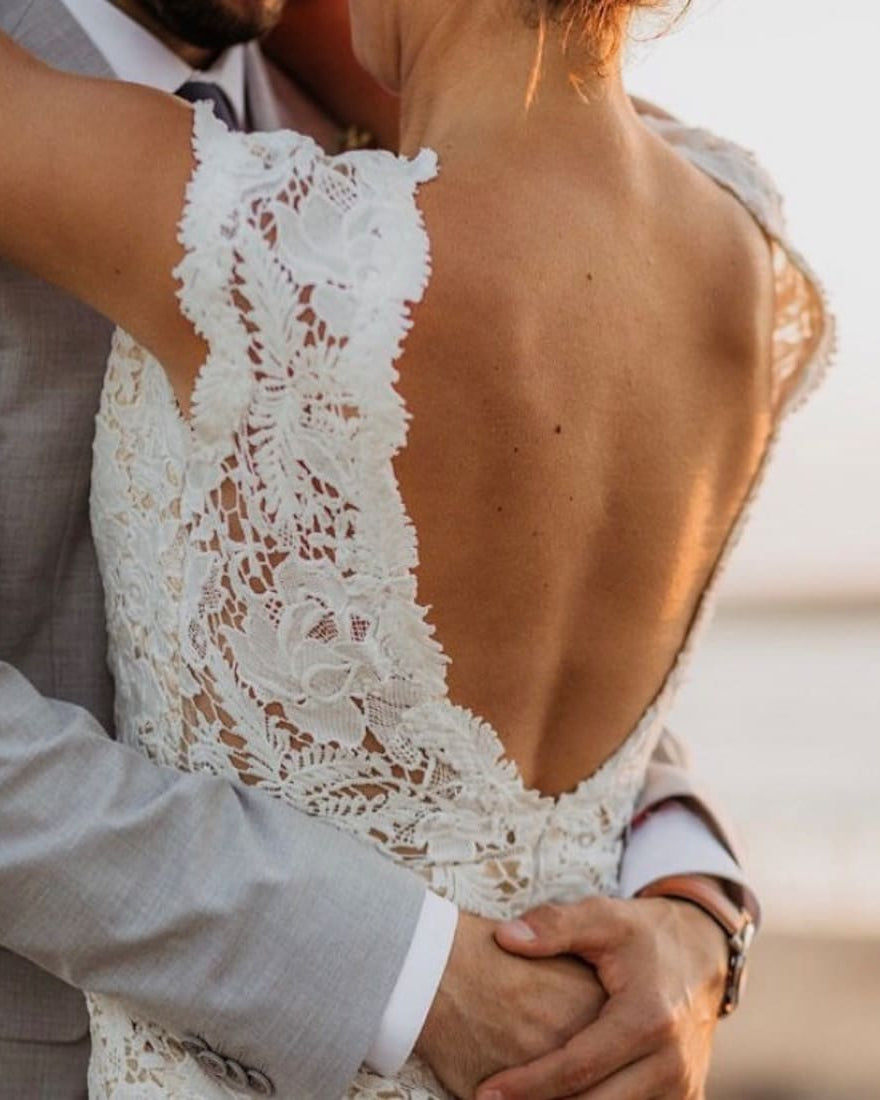 Elegant DIANIRA wedding dress by Atelier Calliste featuring intricate lace details and a flowing train on a bridal model.