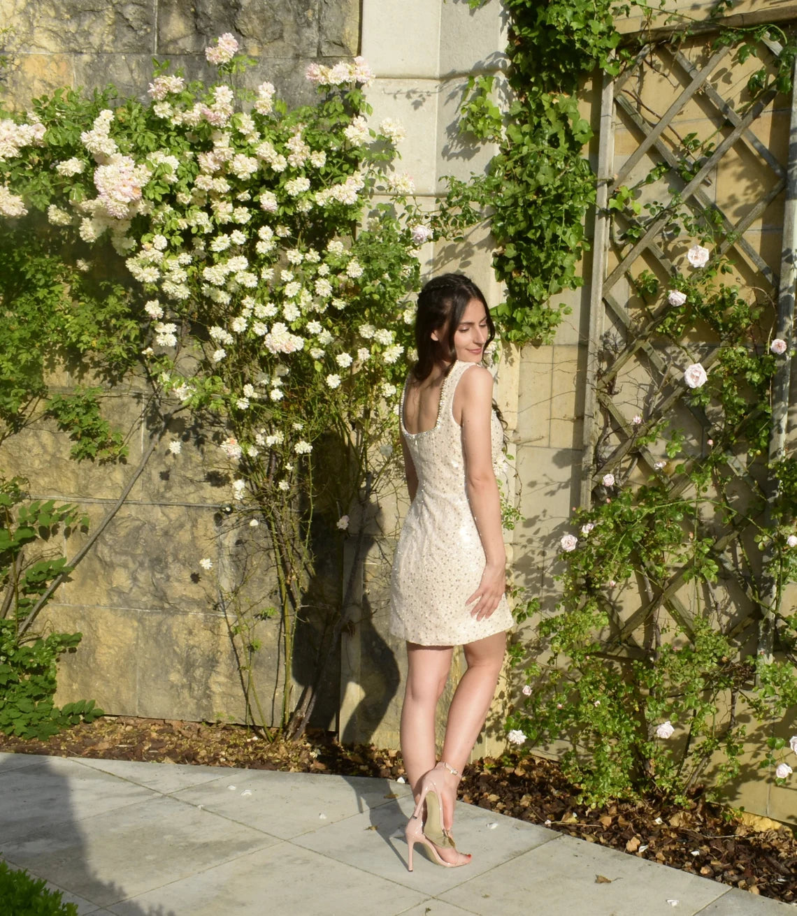 Pink Rose beaded dress by Atelier Calliste, featuring intricate beadwork and elegant fabric, displayed on a hanger.