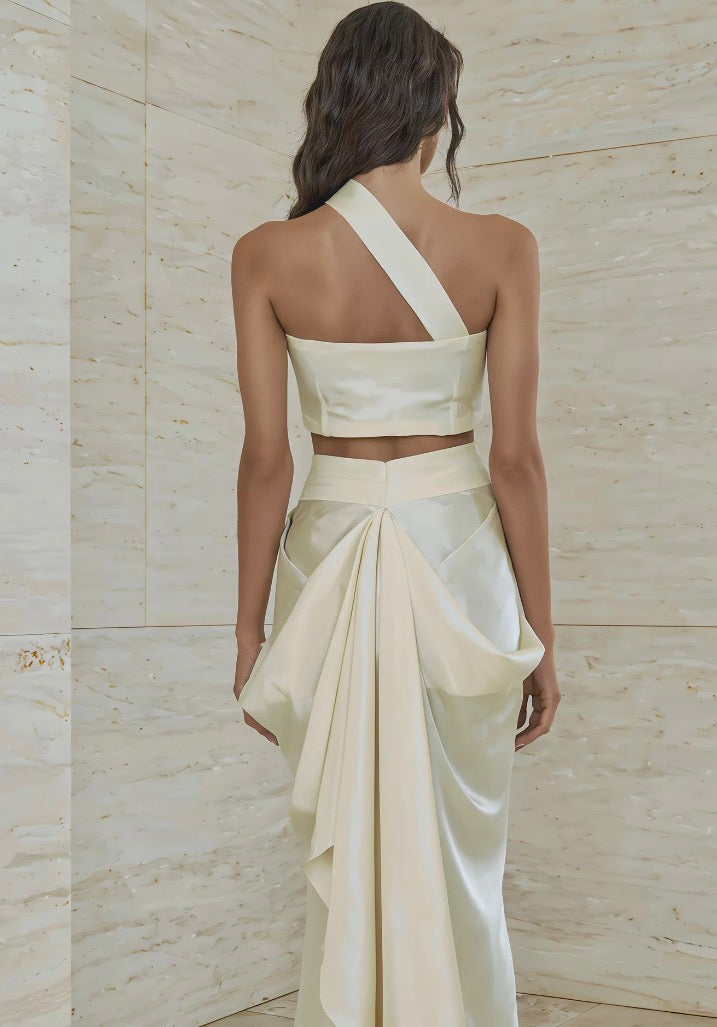 Atelier Calliste Ieria asymmetrical dress with flowing fabric and unique hemline, displayed on a mannequin.
