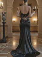 Petra Kara Allure evening dress in elegant black fabric, featuring a fitted silhouette and stylish neckline.