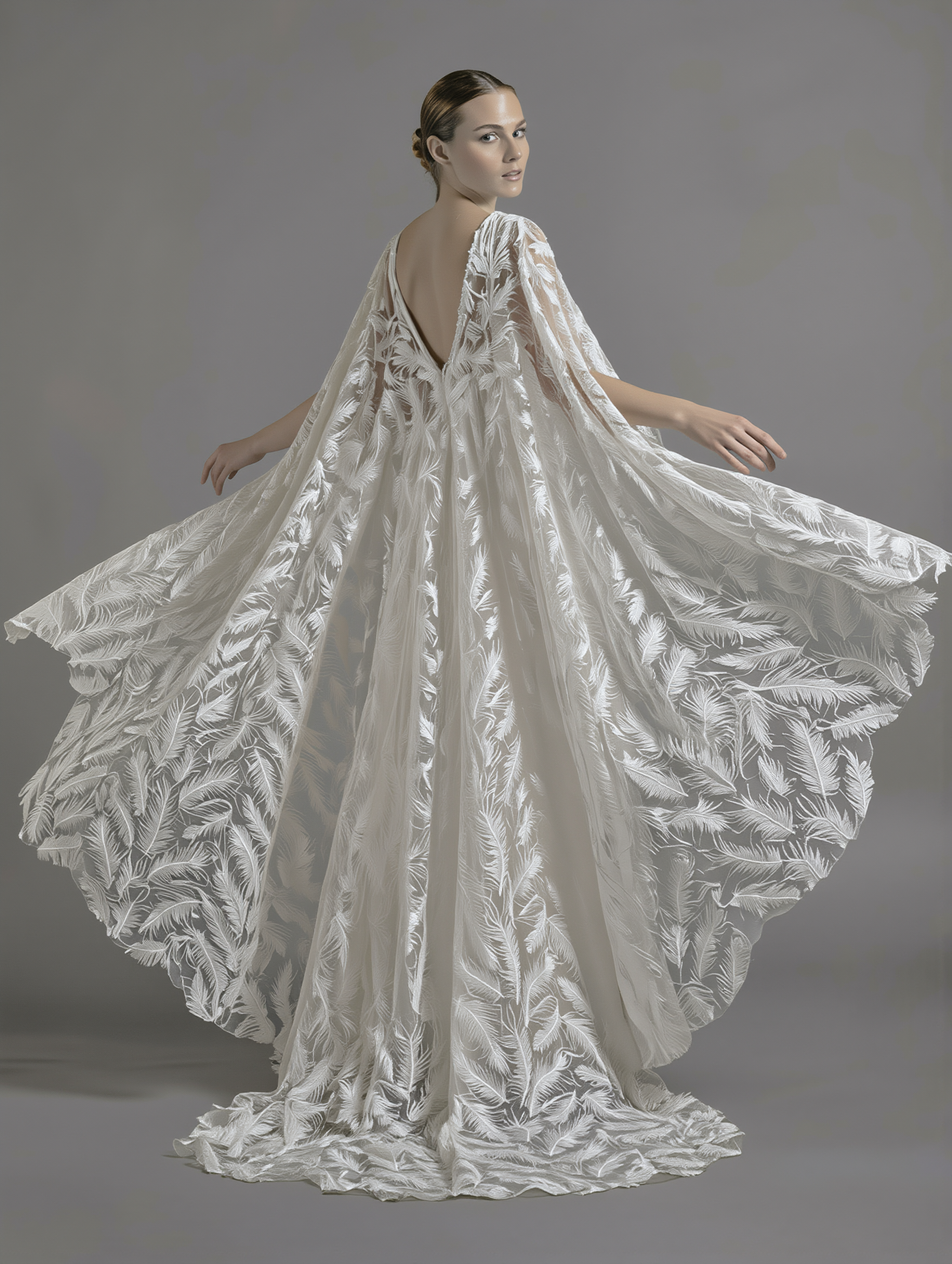 Feather veil and cape by Atelier Calliste, showcasing delicate feather details and flowing fabric for elegant fashion or costume wear.
