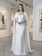 Minimal black cape from Atelier Calliste in size S-XXXL, featuring a sleek, modern design with flowing fabric and minimalist style.
