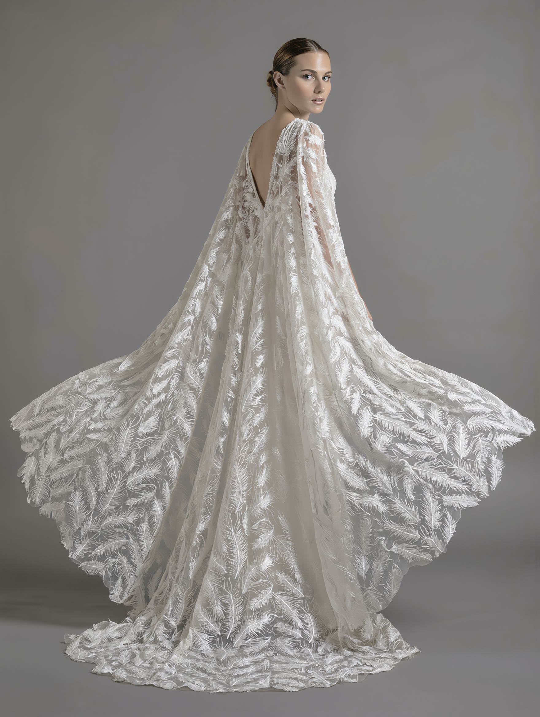 Elegant feather veil and cape by Atelier Calliste, showcasing delicate feather details and flowing fabric for a sophisticated look.