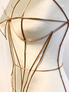 Petra Kara architectural corset dress with structured bodice and flowing skirt, displayed on a mannequin against a neutral backdrop.