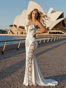 Petra Kara Aelia lace gown featuring intricate lace details and a flowing silhouette, perfect for elegant evening wear.
