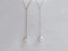 Alyssa lariat necklace with Keishi pearl by PM Atelier, featuring elegant pearl details perfect for brides, shown on a display.