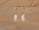 PM Atelier Alyssa Baroque Pearl Organic Drop Mini Huggies earrings with elegant pearl drops and gold hoops.